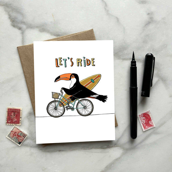 Toucan on a Bicycle with a Surfboard Greeting Card