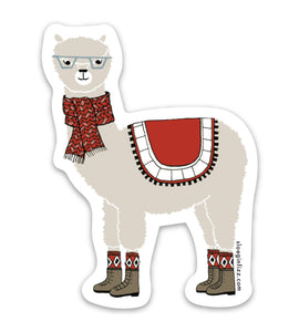 Vinyl sticker with a hand-drawn illustration of an alpaca wearing glasses, a scarf, argyle socks, boots and a decorative blanket 