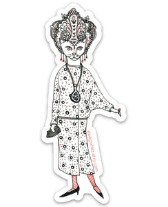 An illustrated die-cut vinyl sticker of a hand-drawn cat decked out in glamorous 1920s style, with a drop waist patterned dress, an elaborate headdress, dangly earrings and a clutch. She has a large pendant around her neck, red stockings and pointy shoes. Seen on a white background. 